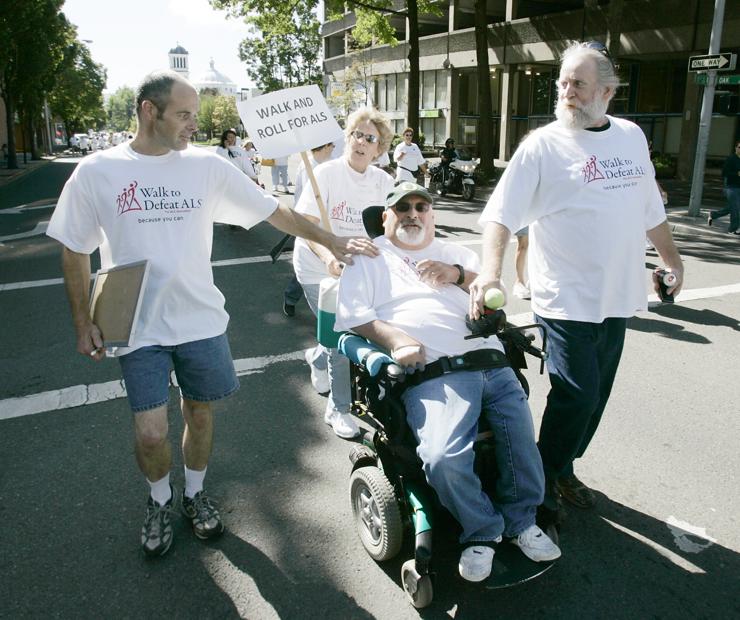 Chris Cole walks with brother Tony Cole as they join friends Lynette Shelley and John Wilson during the Walk to Defeat ALS