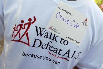 Supporters of Chris Cole wear T-shirts and name tags during the walk