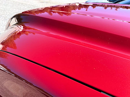 Hood of red truck after being detailed