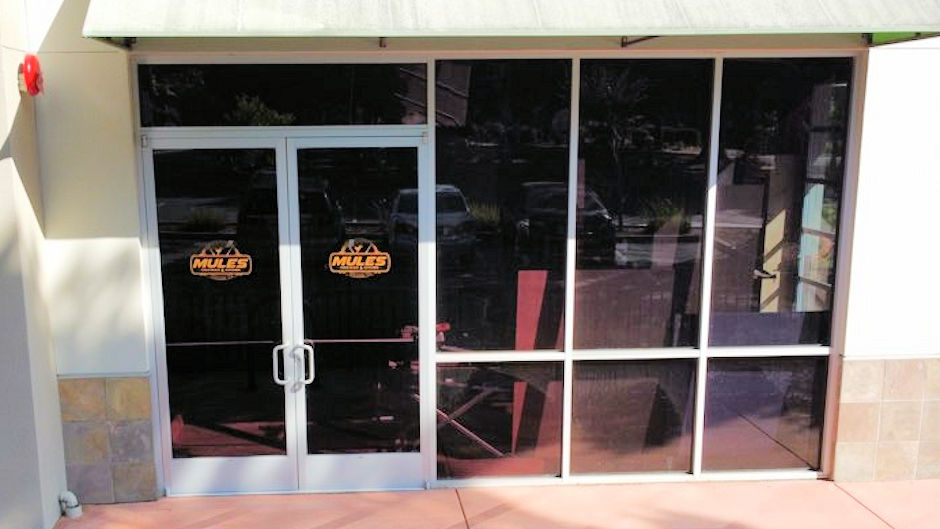 Front door of restaurant showing limited view inside with tint installed
